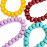Colorful beaded bracelets on a white background