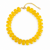 Yellow beaded necklace on a white background