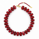 Red beaded necklace with a gold clasp on a white background