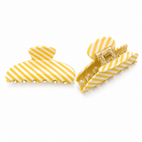 Yellow and white striped hair clips on a white background