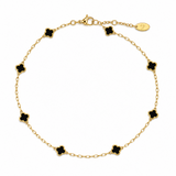 Gold anklet with black clover-shaped charms on a white background