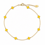 Gold bracelet with yellow clover-shaped charms on a white background