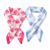 Two square scarves with shell patterns, one pink and one blue, on a white background.