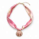 Necklace with pink and gold shell pendant on a white background