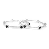 Silver bracelet with black stones on a white background