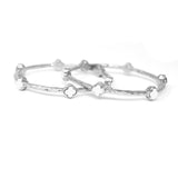 Silver bracelet with clover-shaped charms on a white background
