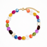 Colorful irregular shapes of beads in a necklace on the white background