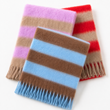 Three striped knit scarves with fringed edges arranged on a white background. The front scarf is brown and light blue, the middle scarf is beige, tan, and pink, and the back scarf is beige, tan, and red.
