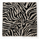 A square textile item, likely a throw blanket or scarf, featuring a black and beige zebra stripe pattern with fringed edges, shown flat against a white background.