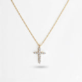 Delicate cross pendant necklace featuring shimmering cubic zirconia accents on a fine gold-tone chain, offering a subtle yet radiant touch for everyday elegance.