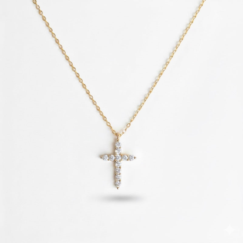 Delicate cross pendant necklace featuring shimmering cubic zirconia accents on a fine gold-tone chain, offering a subtle yet radiant touch for everyday elegance.
