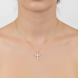 Delicate cross pendant necklace featuring shimmering cubic zirconia accents on a fine gold-tone chain, offering a subtle yet radiant touch for everyday elegance.
