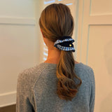 Chic hair scrunchie with a classic preppy design, featuring bold contrasting borders and a tailored look—perfect for polished, everyday styling