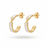 Gold hoop earrings with white accents on a light beige background