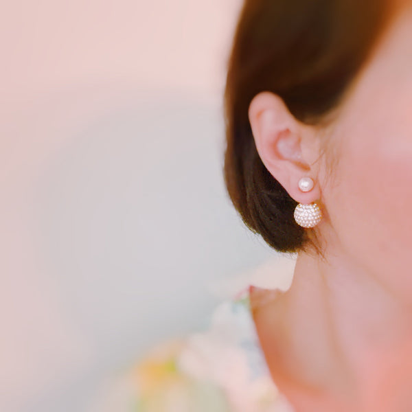Shiny gold tone disco ball earrings with an elegant pearl back detail, adding a fun yet classy twist to your party look.