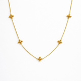 Dotty cross gold necklace on the white background