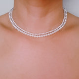 Set of two versatile pearl necklaces featuring luminous pearls in varying sizes, designed with magnetic clasps for easy wear and styling; can be worn individually or linked together for a longer layered look.