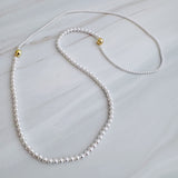 Set of two versatile pearl necklaces featuring luminous pearls in varying sizes, designed with magnetic clasps for easy wear and styling; can be worn individually or linked together for a longer layered look.