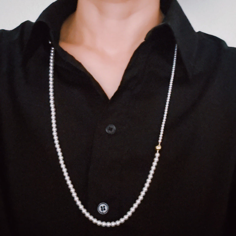 Set of two versatile pearl necklaces featuring luminous pearls in varying sizes, designed with magnetic clasps for easy wear and styling; can be worn individually or linked together for a longer layered look.