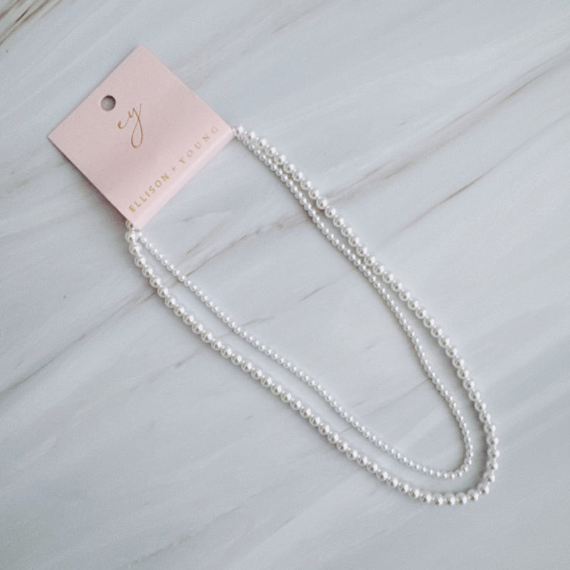 Set of two versatile pearl necklaces featuring luminous pearls in varying sizes, designed with magnetic clasps for easy wear and styling; can be worn individually or linked together for a longer layered look.