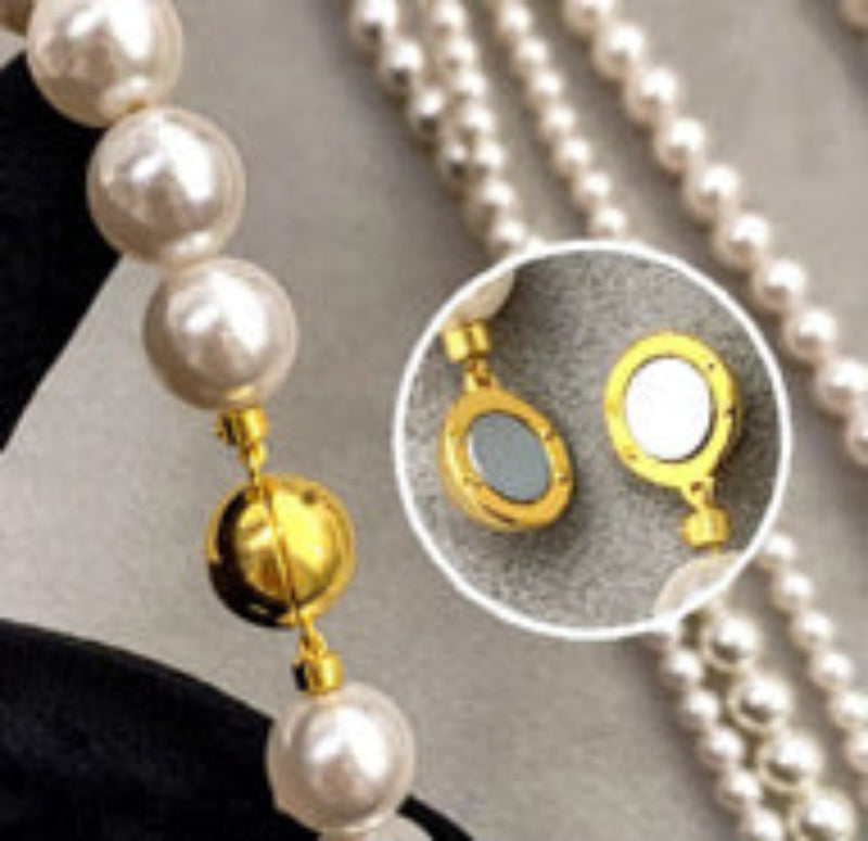 Set of two versatile pearl necklaces featuring luminous pearls in varying sizes, designed with magnetic clasps for easy wear and styling; can be worn individually or linked together for a longer layered look.