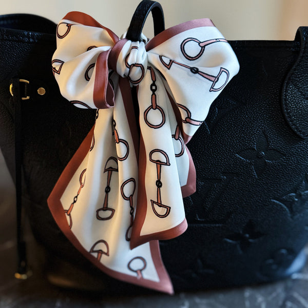 Scarf featuring an elegant equestrian-inspired chain link border design, ideal for accessorizing the neck, hair, or handbag handles.