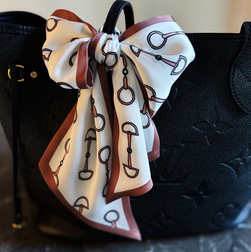 Scarf featuring an elegant equestrian-inspired chain link border design, ideal for accessorizing the neck, hair, or handbag handles.