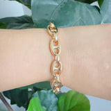 Gold-tone bracelet featuring a twisted, horse-bit-inspired design with interlocking links, offering an elegant equestrian flair and flexible fit.