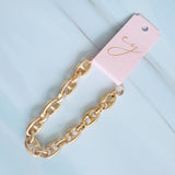 Gold-tone bracelet featuring a twisted, horse-bit-inspired design with interlocking links, offering an elegant equestrian flair and flexible fit.