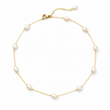 Gold necklace with pearls on a white background