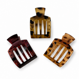 Three tortoiseshell hair clips on a white background