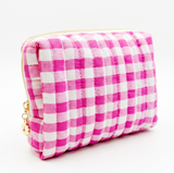 Gingham quilted cosmetic case in pink with gold daisy zipper pull in white background