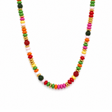 a necklace with different colors and shapes of beads in festive mood. white background