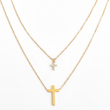 Gold-toned layered necklace featuring two sleek cross pendants, one on each tier of delicate chain links for a modern, faith-inspired design.