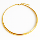 Gold-tone modern herringbone necklace featuring a sleek, flat chain design with subtle reflective shine and a secure clasp closure