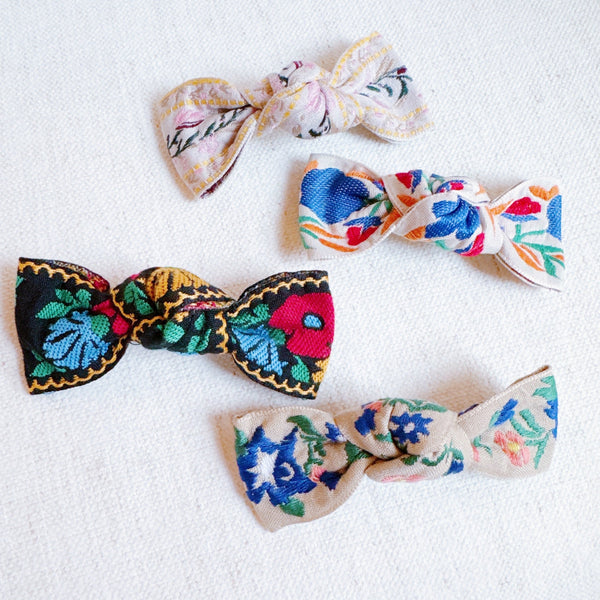 Elegant hair clip featuring intricate French floral embroidery on a soft fabric base—offering a timeless, romantic accent to any hairstyle.