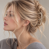 Close-up of a model wearing the platinum French Modern Acetate Claw Clip in a messy updo