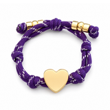 a purple rope bracelet with gold heart charm on the white background