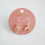 Artistic drop earrings featuring prism-cut gemstones framed by lustrous gold-tone metal. The angular yet fluid silhouette captures light beautifully, making each pair an elegant statement piece.