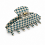 Blue and white checkered hair clip on a white background