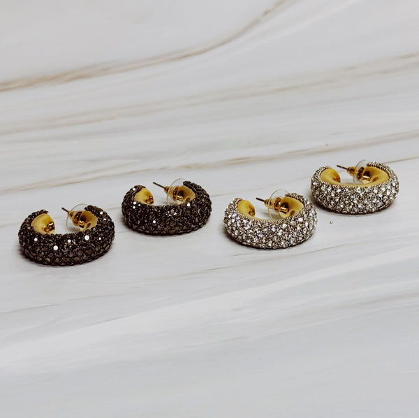 A pair of gold-tone hoop earrings adorned with shimmering rhinestones