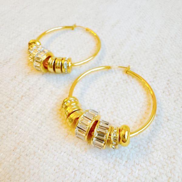 Elegant hoop earrings adorned with shimmering crystal accents and nature-inspired details—perfect for adding a touch of glam and garden charm to any outfit.
