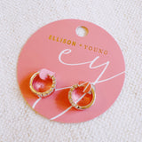 Contoured silver-tone huggie earrings featuring a sleek sculpted shape with a subtle strip of sparkling stones along one edge for a hint of glam.