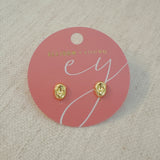 Gold-tone dome stud earrings with a smooth, pebble-like shape and a polished finish for a modern, minimalist look.