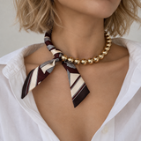 Model wearing the Golden Bead Scarf-Tie Necklace in Brown with an open white button-down shirt