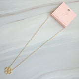 Elegant gold clover-shaped pendant encrusted with shimmering clear crystals. The Golden Clover Crystal Necklace features heart-shaped petals and a radiant gold finish, blending modern charm with timeless sparkle.