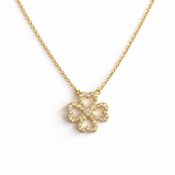 Elegant gold clover-shaped pendant encrusted with shimmering clear crystals. The Golden Clover Crystal Necklace features heart-shaped petals and a radiant gold finish, blending modern charm with timeless sparkle.