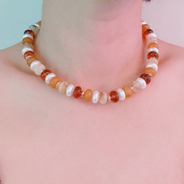 Beaded necklace featuring a blend of golden, amber, and brown-toned beads with subtle shimmer and natural variation, creating an earthy yet refined look.