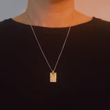 Elegant two-tone necklace featuring a sleek rectangular gold bar pendant on a silver-metal chain, blending modern edge with classic shine