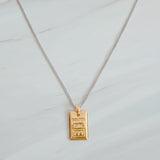 Elegant two-tone necklace featuring a sleek rectangular gold bar pendant on a silver-metal chain, blending modern edge with classic shine